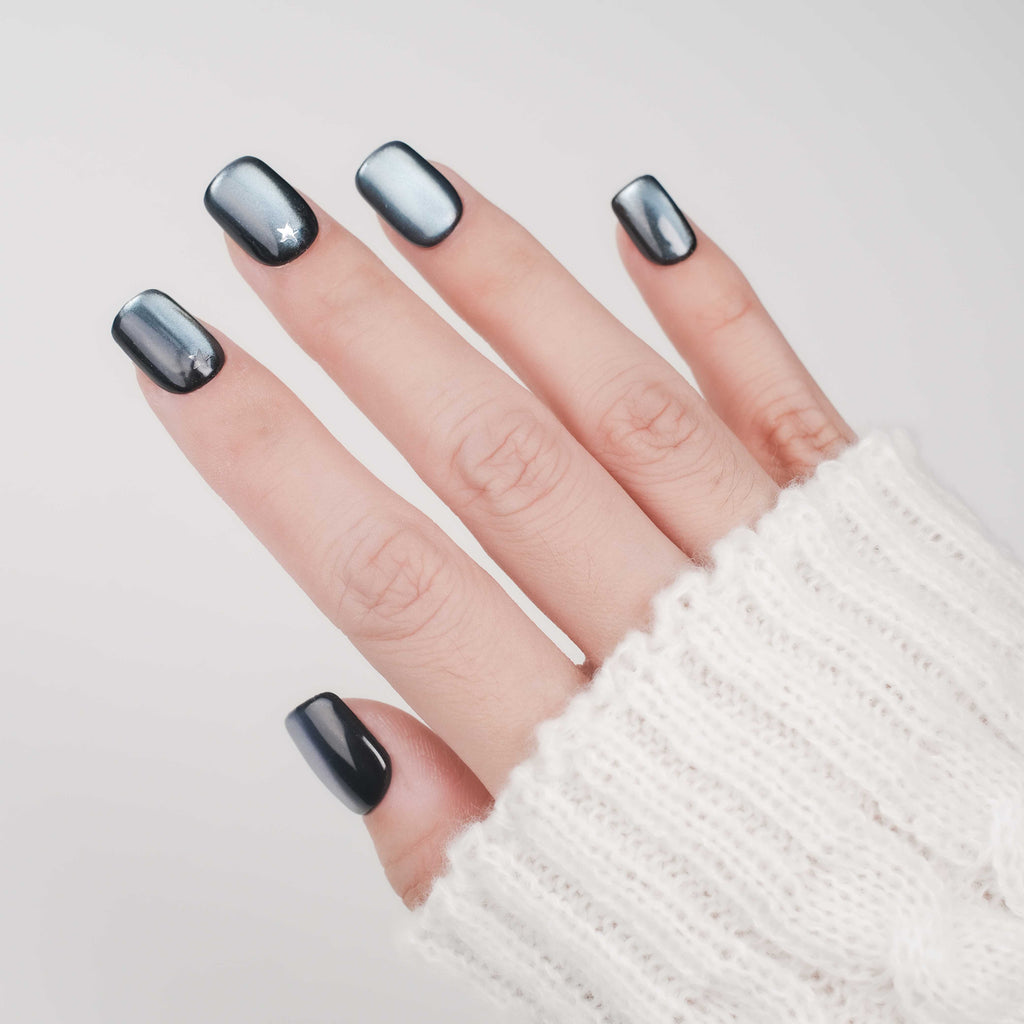 Short square press-on nails by Nailique featuring blue cat eye design, silver stars, reusable tips, and lamp-curable glue for salon-quality manicure