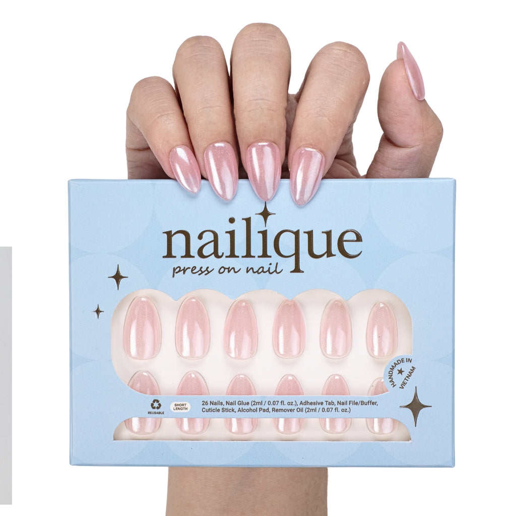 Handmade short almond press on nails in baby pink chrome with glitter shimmer, reusable gel tips, and lamp-curable glue by Nailique.