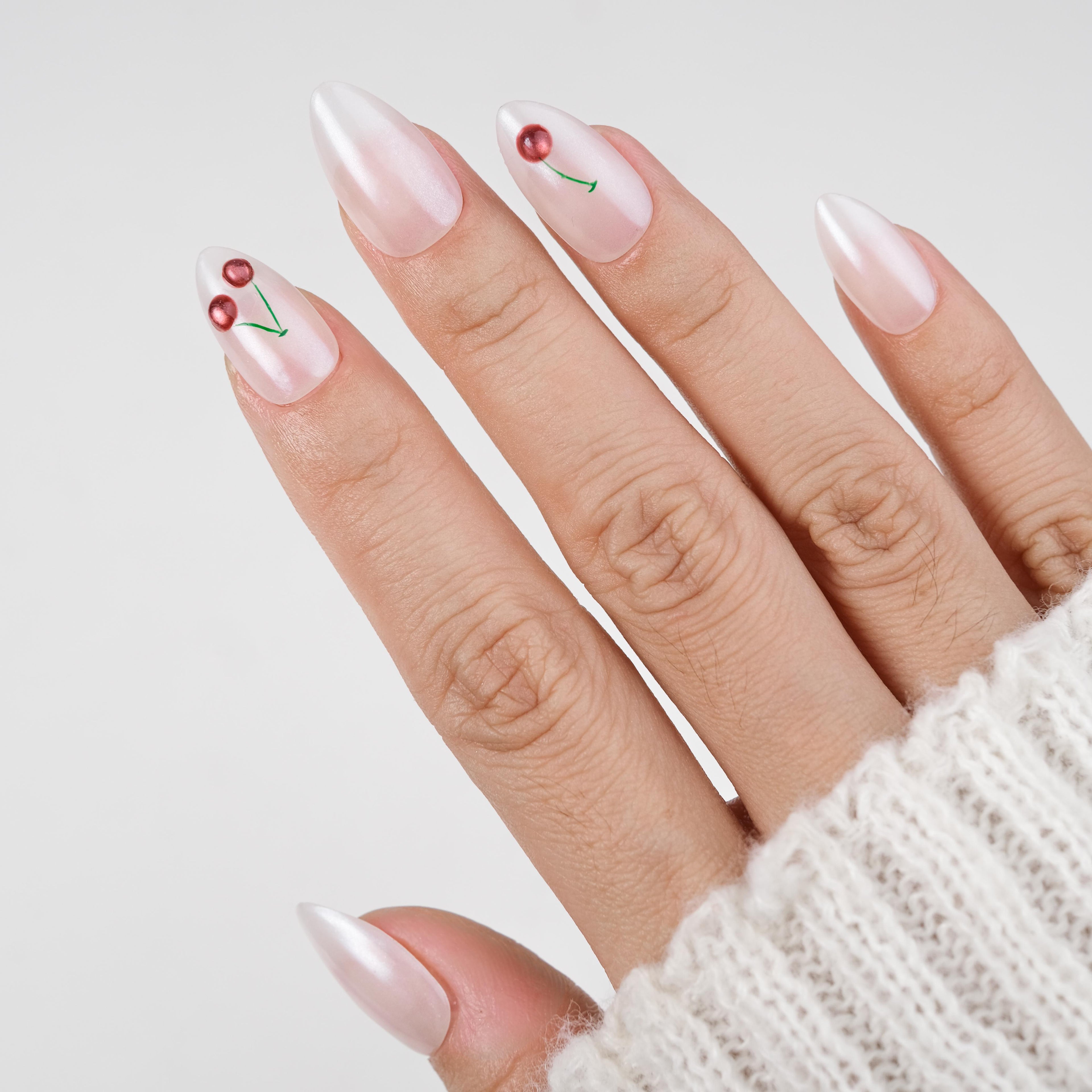 Handmade short almond press on nails by Nailique with soft gel, milky pearl finish, 3D cherry design, reusable tips, and glue included.