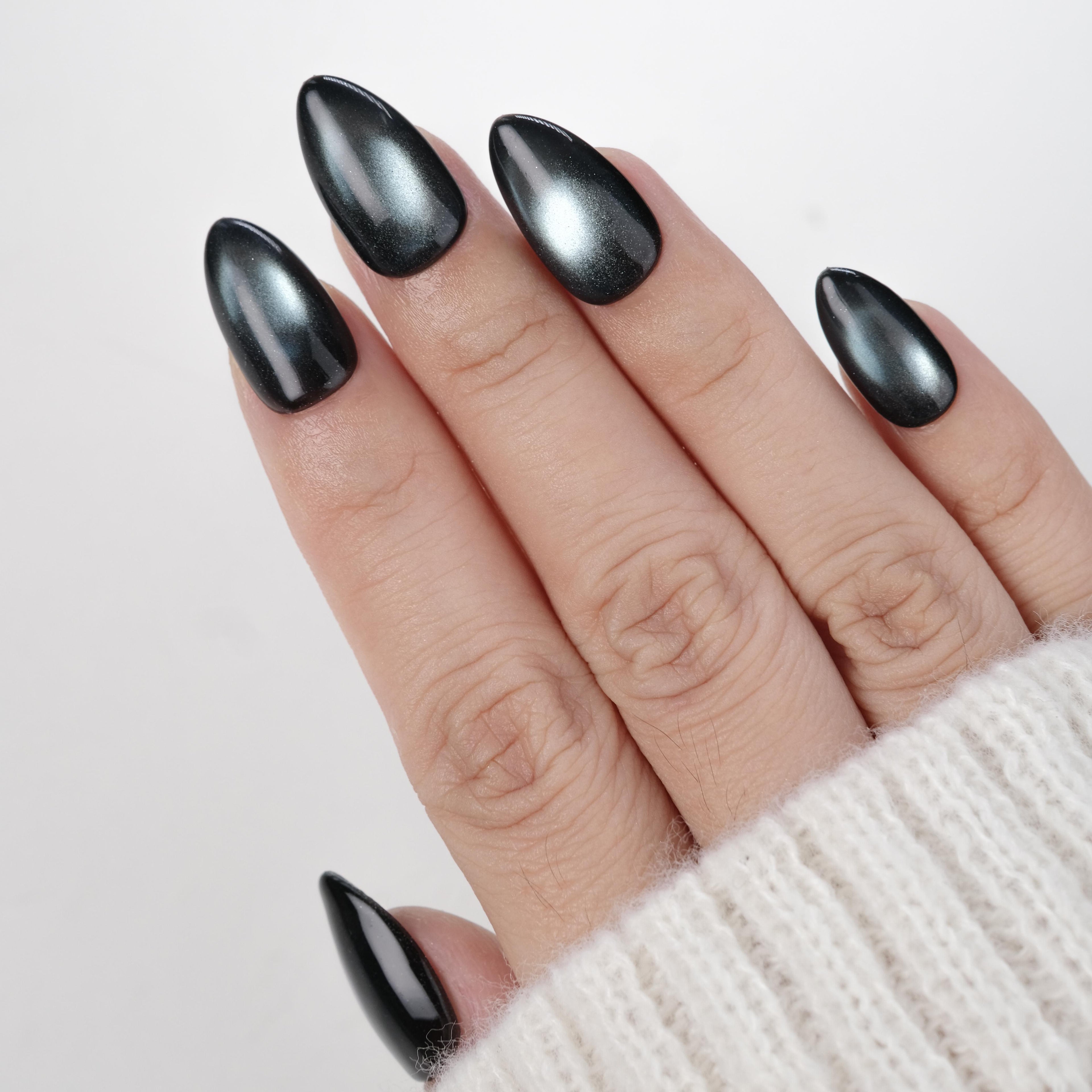 Handmade short almond press-on nails by Nailique in midnight blue black with cat eye shimmer, 26 reusable gel tips with glue and remover