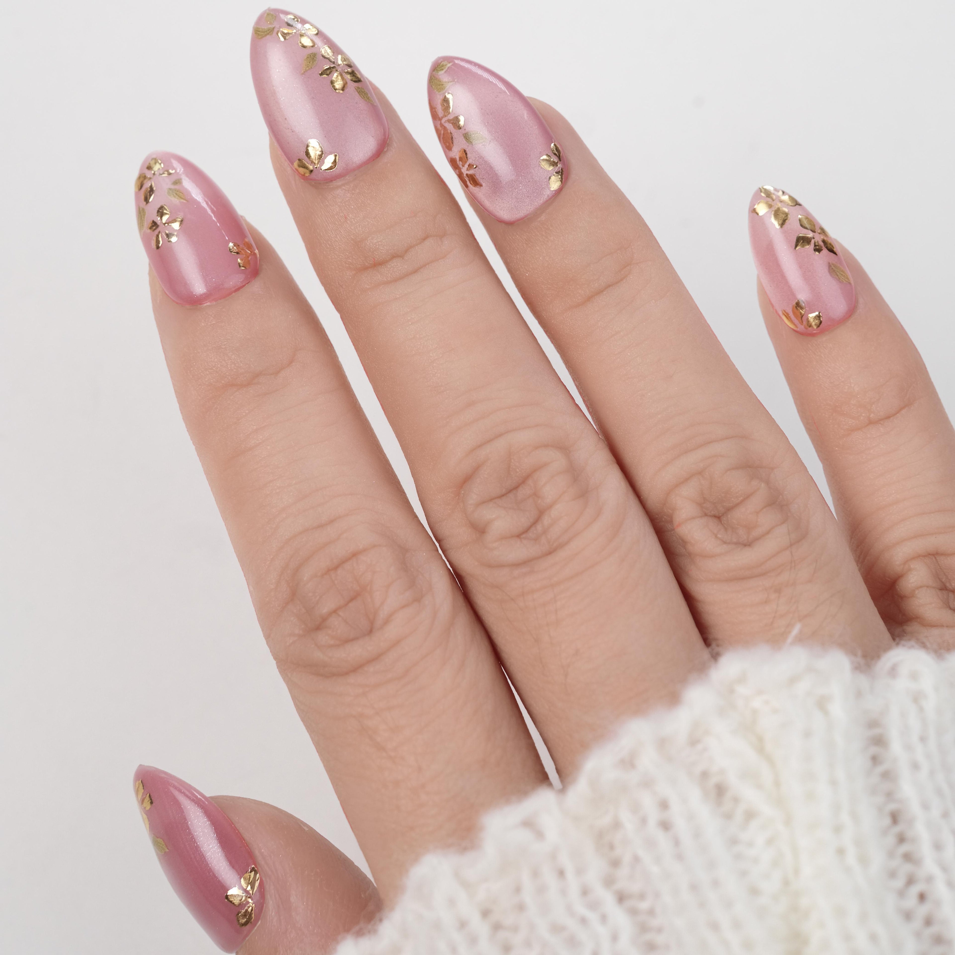 Handmade pink cat eye soft gel press-on nails with gold foil floral design, short almond shape, 26 reusable tips with glue and remover.