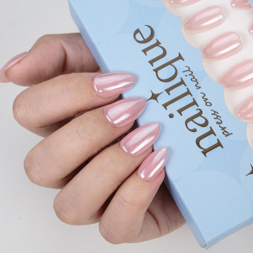 Handmade short almond press-on nails in baby pink chrome with glitter shimmer, 26 reusable tips with lamp-curable glue.