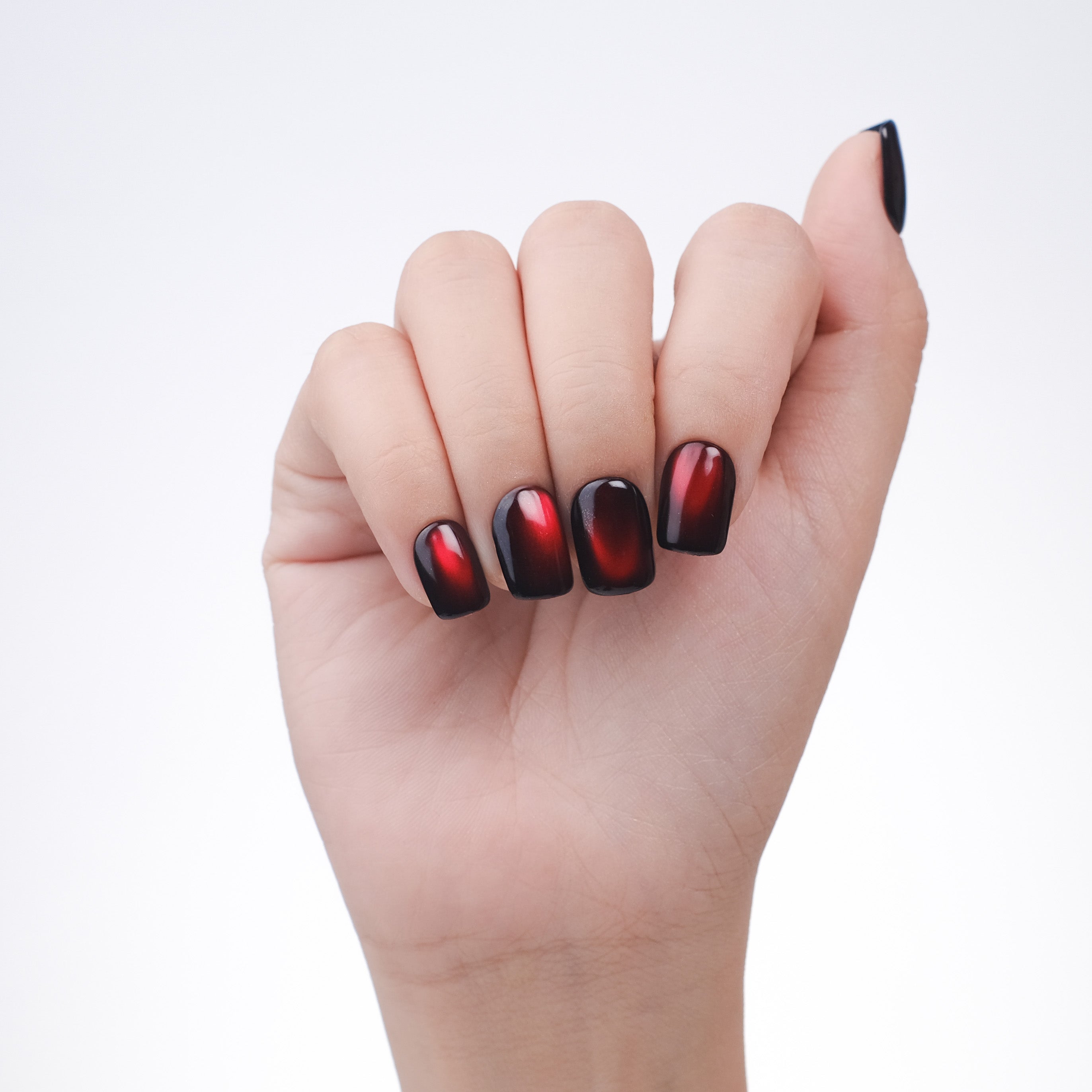 Handmade burgundy red cat eye press-on nails in short square shape, with reusable tips and lamp-curable glue for salon-quality manicure.
