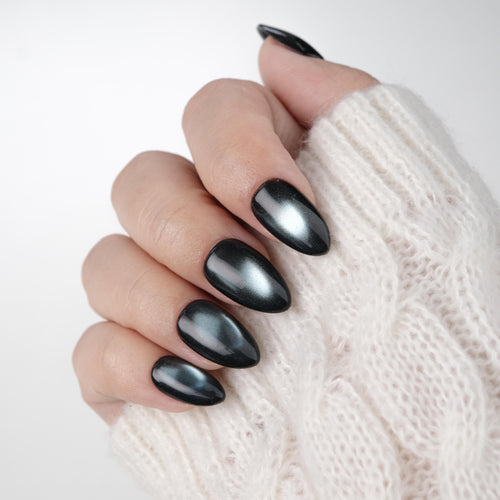Short almond press-on nails by Nailique featuring handmade cat eye soft gel in midnight blue black shimmer, 26 reusable tips with glue.
