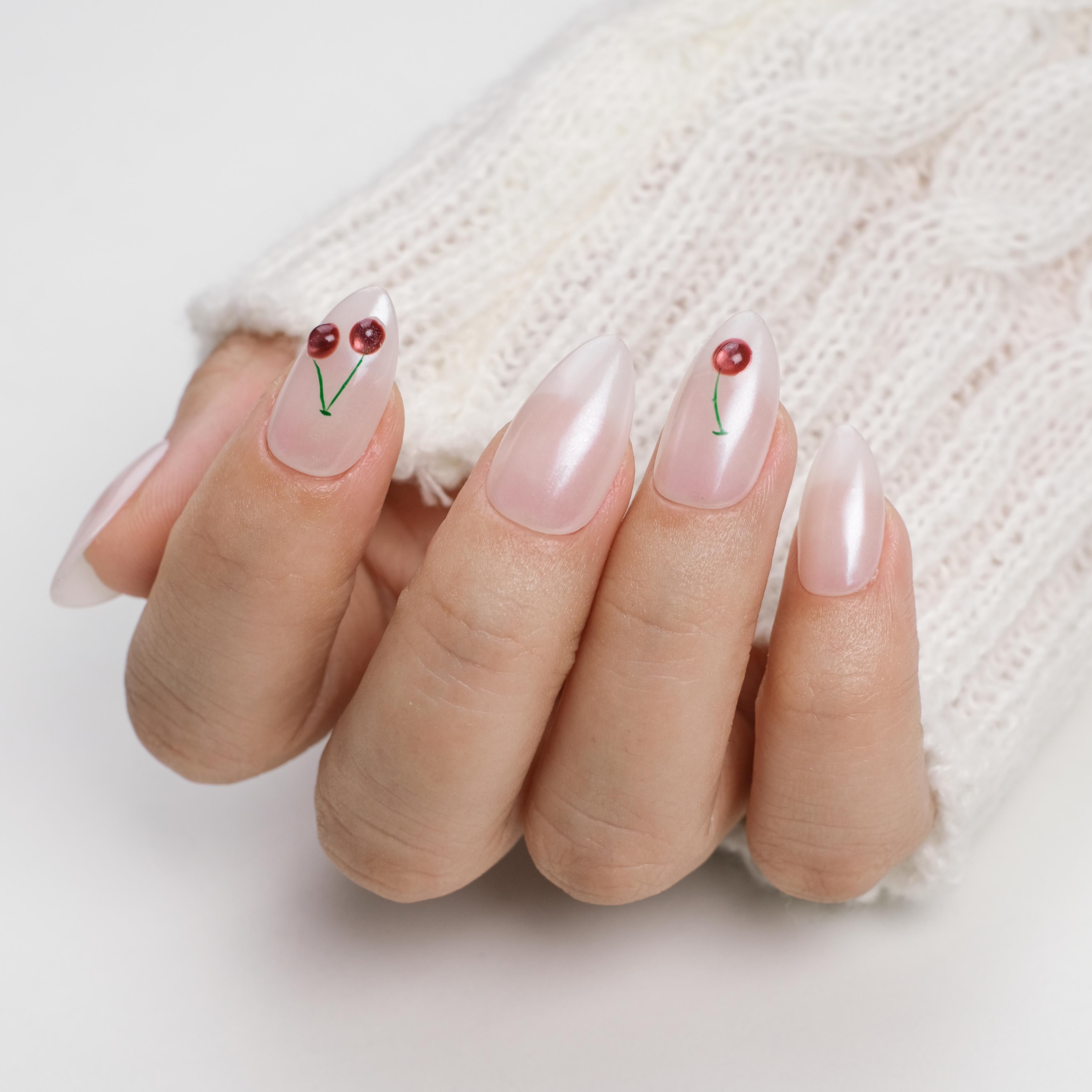 Short almond press on nails by Nailique with soft gel finish, hand-painted 3D cherry design, reusable with glue and remover.