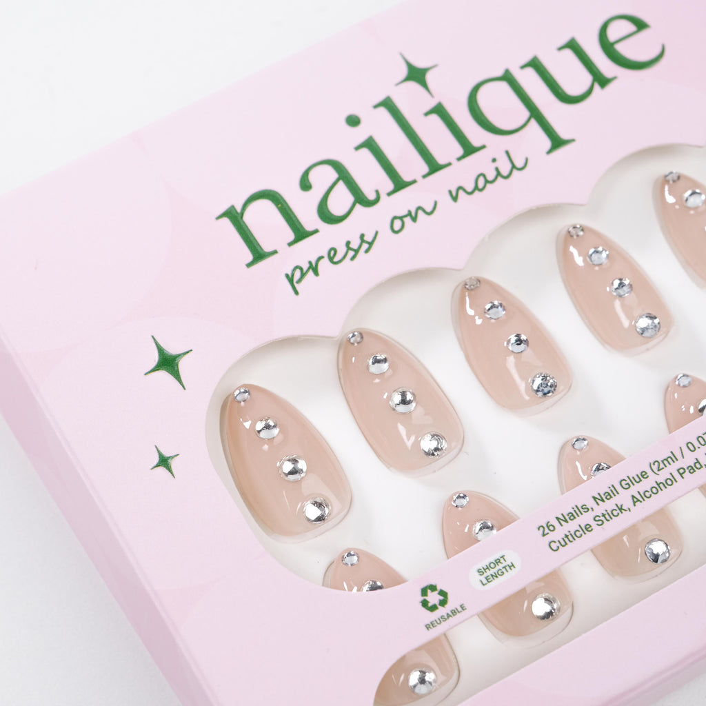 Nailique short almond press-on nails in nude with silver crystal rhinestones and minimal sparkle, reusable 26-piece gel manicure set