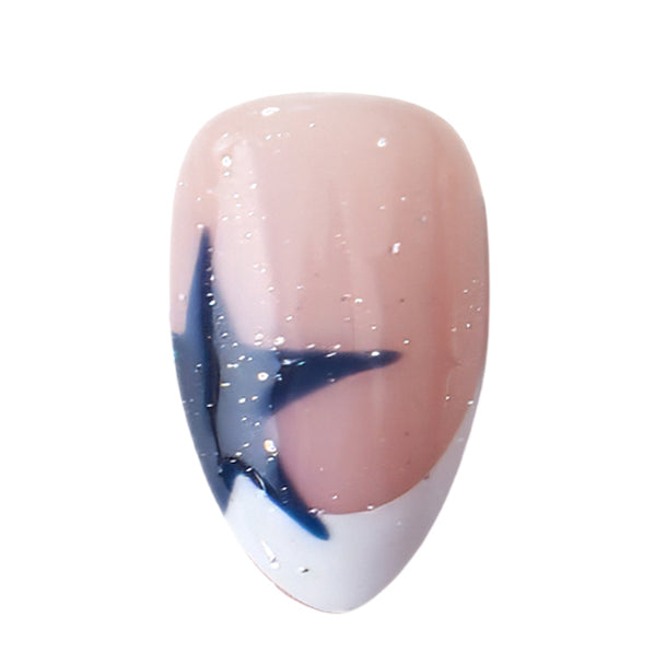 Nailique short almond press-on nails with navy blue French tips, star glitter shimmer, and soft gel finish, displayed on a thumb.
