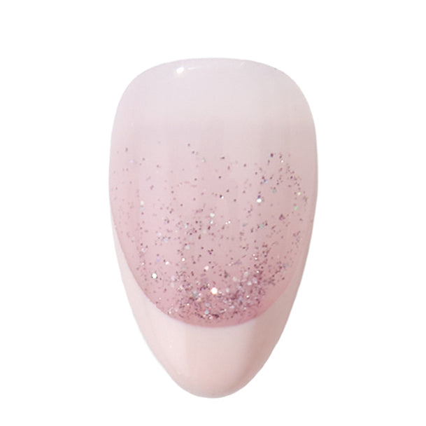 Handmade short almond press-on nails by Nailique with soft pink French tips, glitter shimmer, and ombre design.